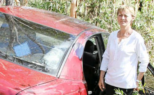 Christine McLaren escaped from her Holden Commodore which was swept off Goodwood Road by a wall of water while she was trying to cross a flooded culvert during Sunday’s flooding. Christine McLaren escaped from her Holden Commodore which was swept off Goodwood Road by a wall of water while she was trying to cross a flooded culvert during Sunday’s flooding.